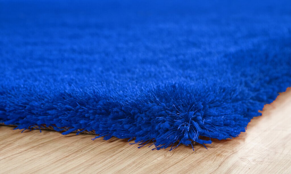 Chubby Blue Area Rug showcasing a soft shaggy texture in solid blue color, perfect for home decor.