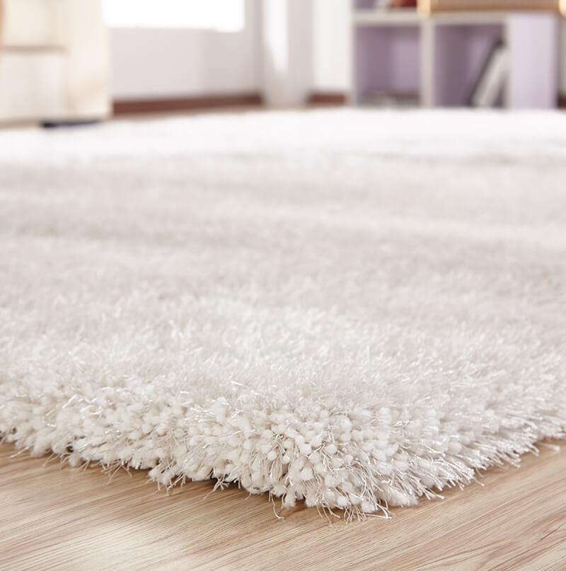 Chubby White Area Rug with soft shaggy texture, hand-tufted from 100% polyester, perfect for home decor.