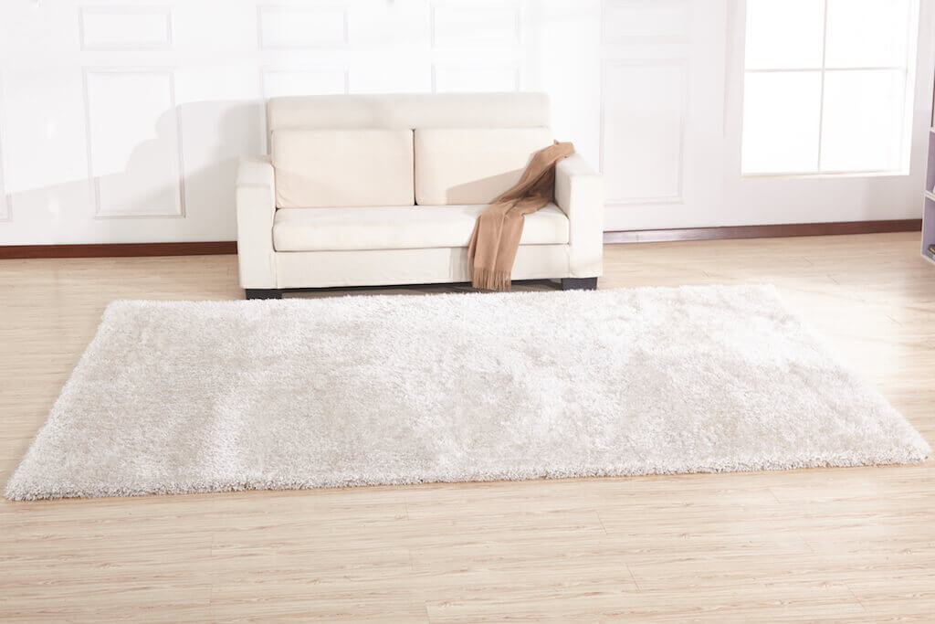 Chubby White Area Rug with soft shaggy texture, hand-tufted from 100% polyester, perfect for home decor.