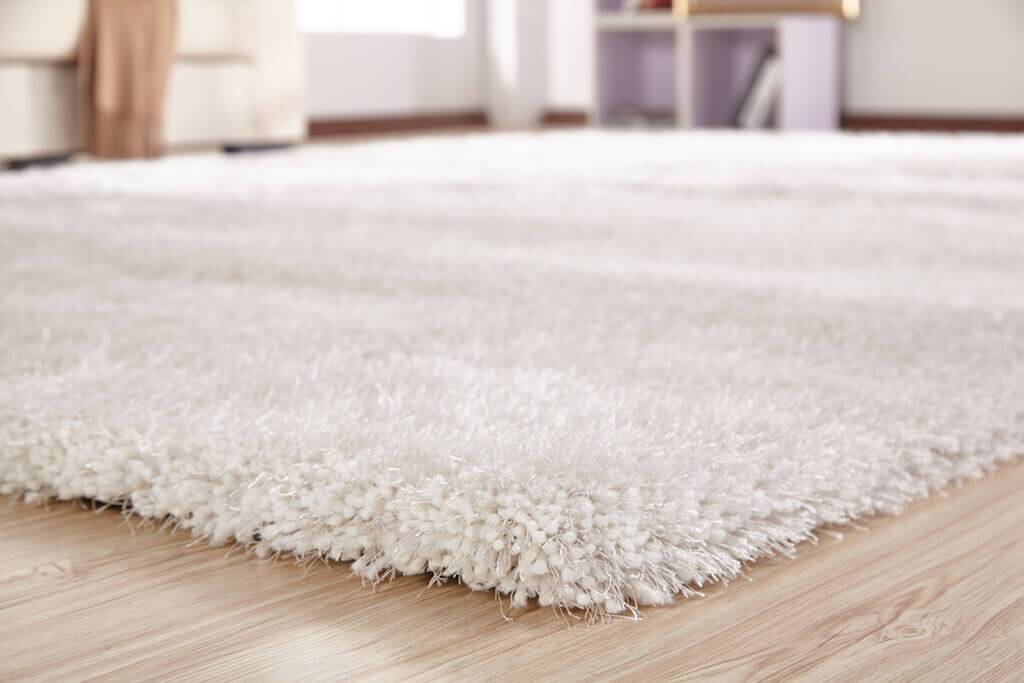 Chubby White Area Rug with soft shaggy texture, hand-tufted from 100% polyester, perfect for home decor.