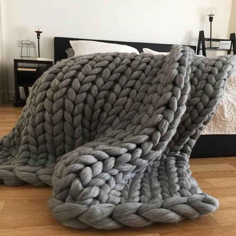 A cozy, hand-woven chunky knit blanket in soft acrylic fibers, measuring 120*150cm, showcasing its unique texture and vibrant colors.