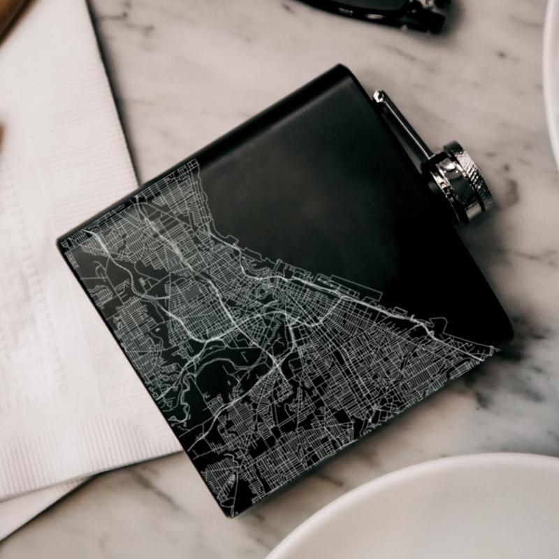 Custom engraved matte black hip flask featuring a detailed map of Cleveland, Ohio with coordinates.