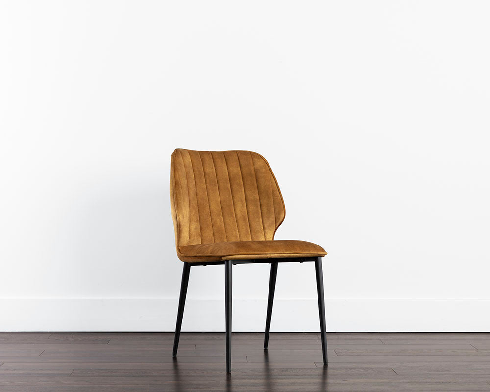 Clinton Dining Chair in Black with Nono Tapenade Gold fabric, featuring channel tufting and sturdy black iron legs.