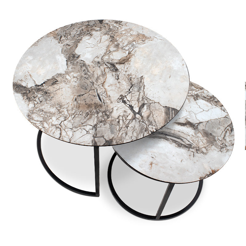 JULIUS Coffee Table Set featuring beige marble effect and black metal base, showcasing two round tables in a stylish living room setting.