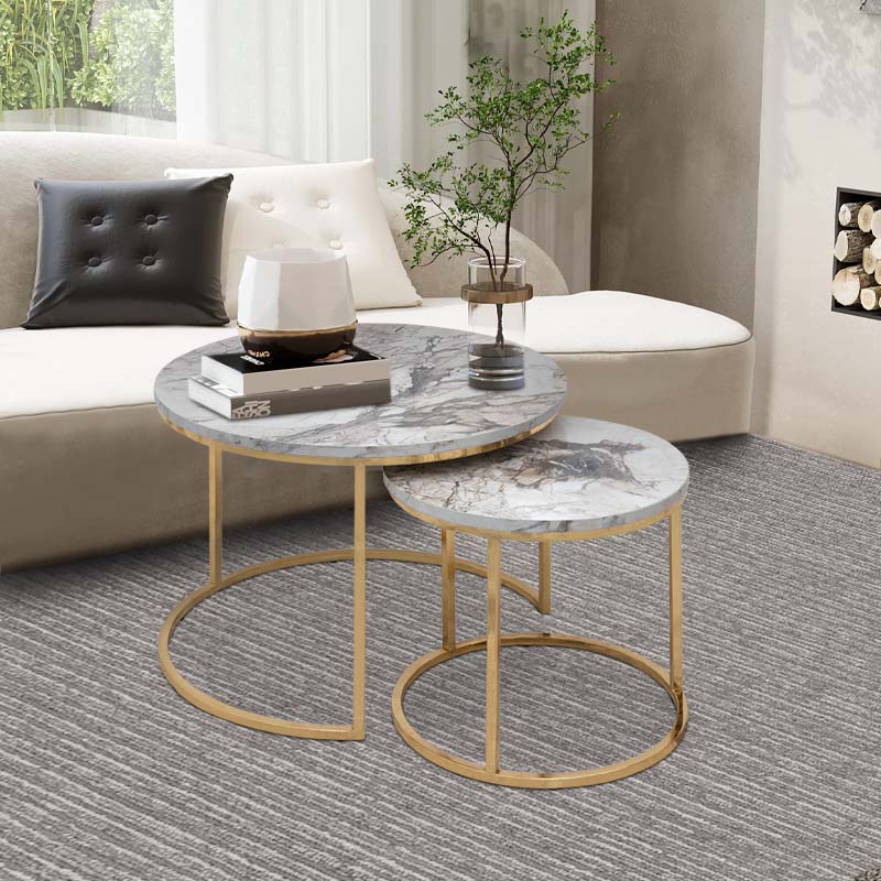 JULIUS Coffee Table Set featuring beige marble effect and gold metal base, showcasing two round tables in a stylish living room setting.