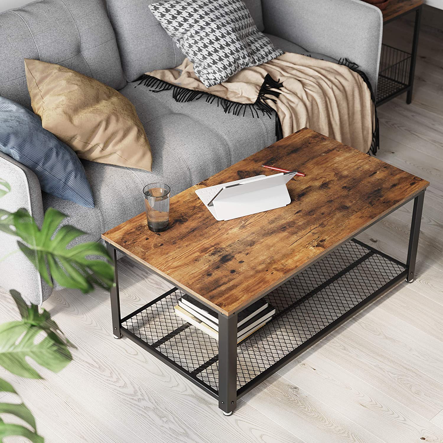 Rustic brown coffee table with metal frame and storage shelf, showcasing a stylish design suitable for any living room.