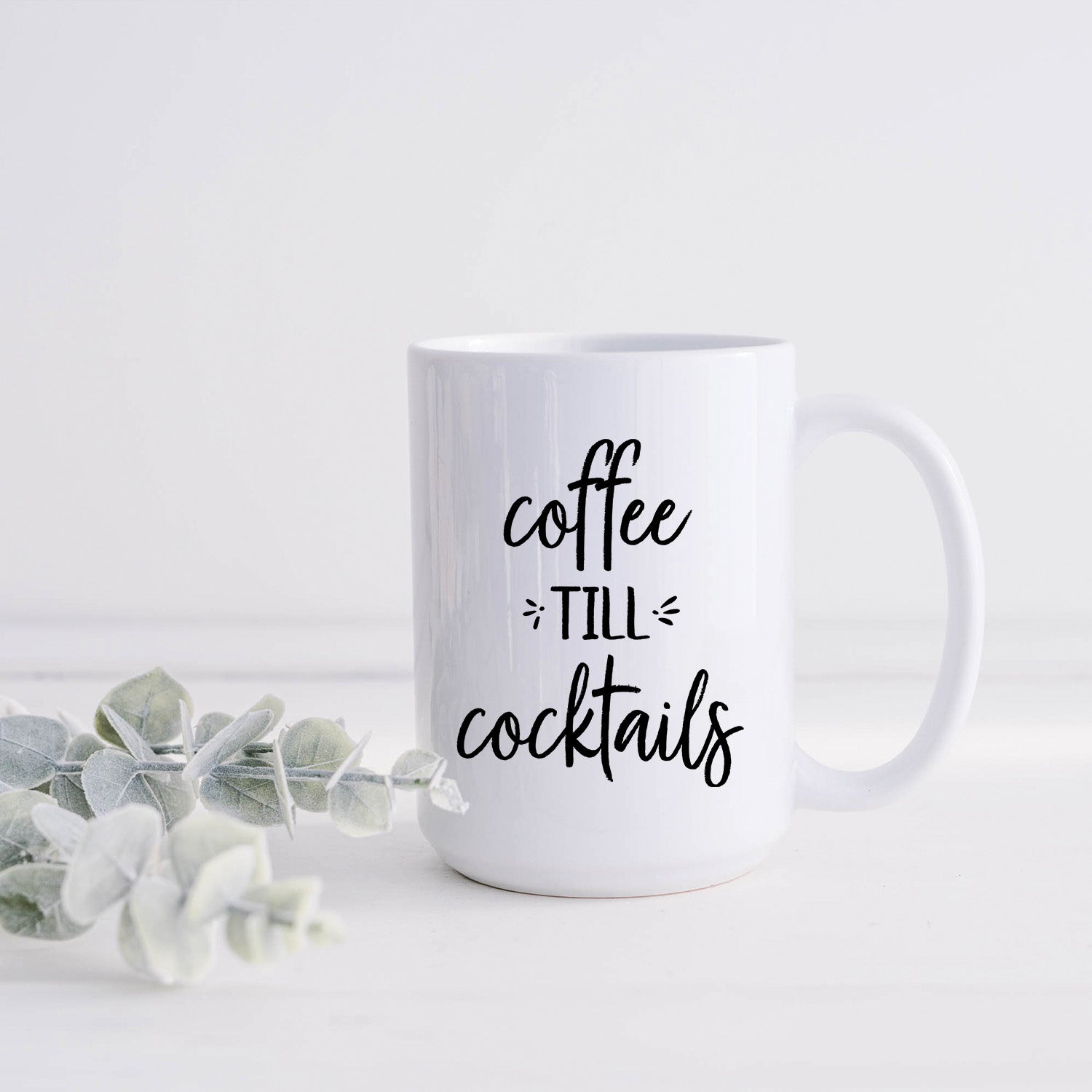 A glossy white 15oz ceramic mug with a vibrant print, perfect for coffee or cocktails.