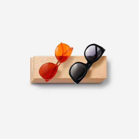 Stylish Cool sunglass holder displaying multiple sunglasses on a wall, showcasing its elegant design and natural wood finish.