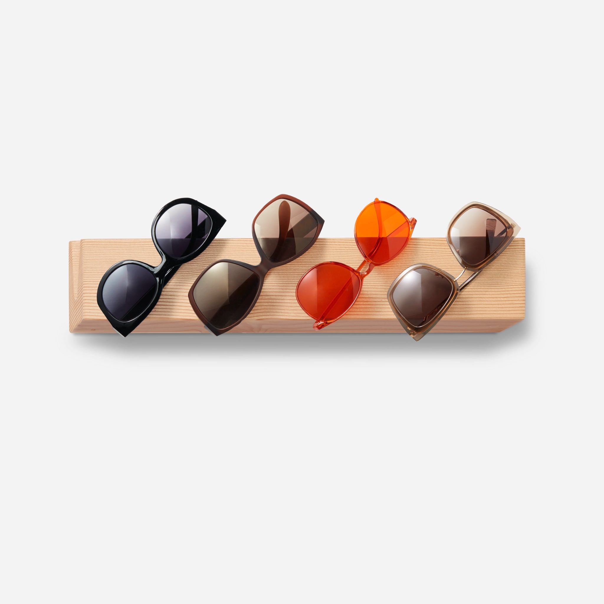 Stylish Cool sunglass holder displaying multiple sunglasses on a wall, showcasing its elegant design and natural wood finish.