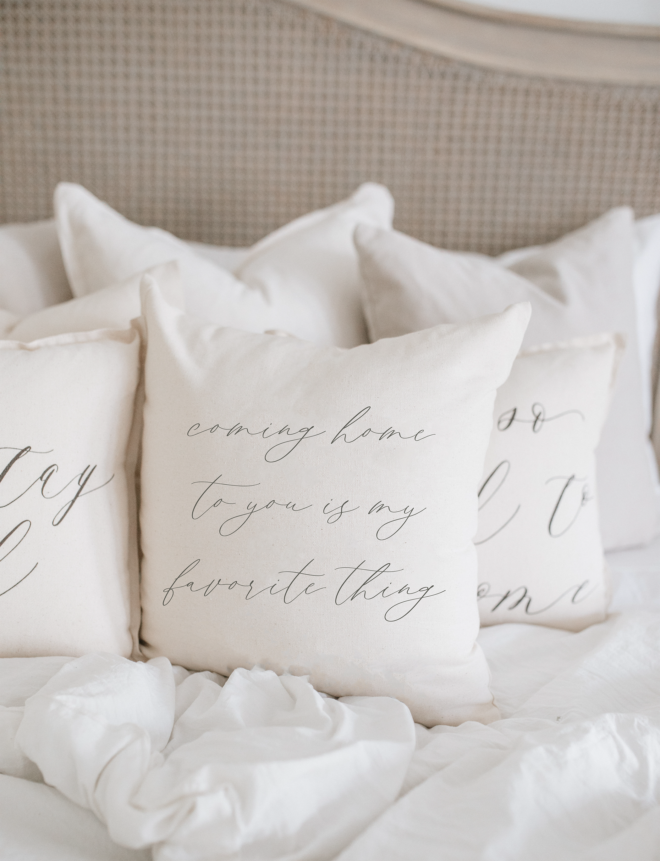 A cozy pillow with the quote 'Coming Home To You Is My Favorite Thing' in elegant calligraphy, made from 100% natural cotton fabric.