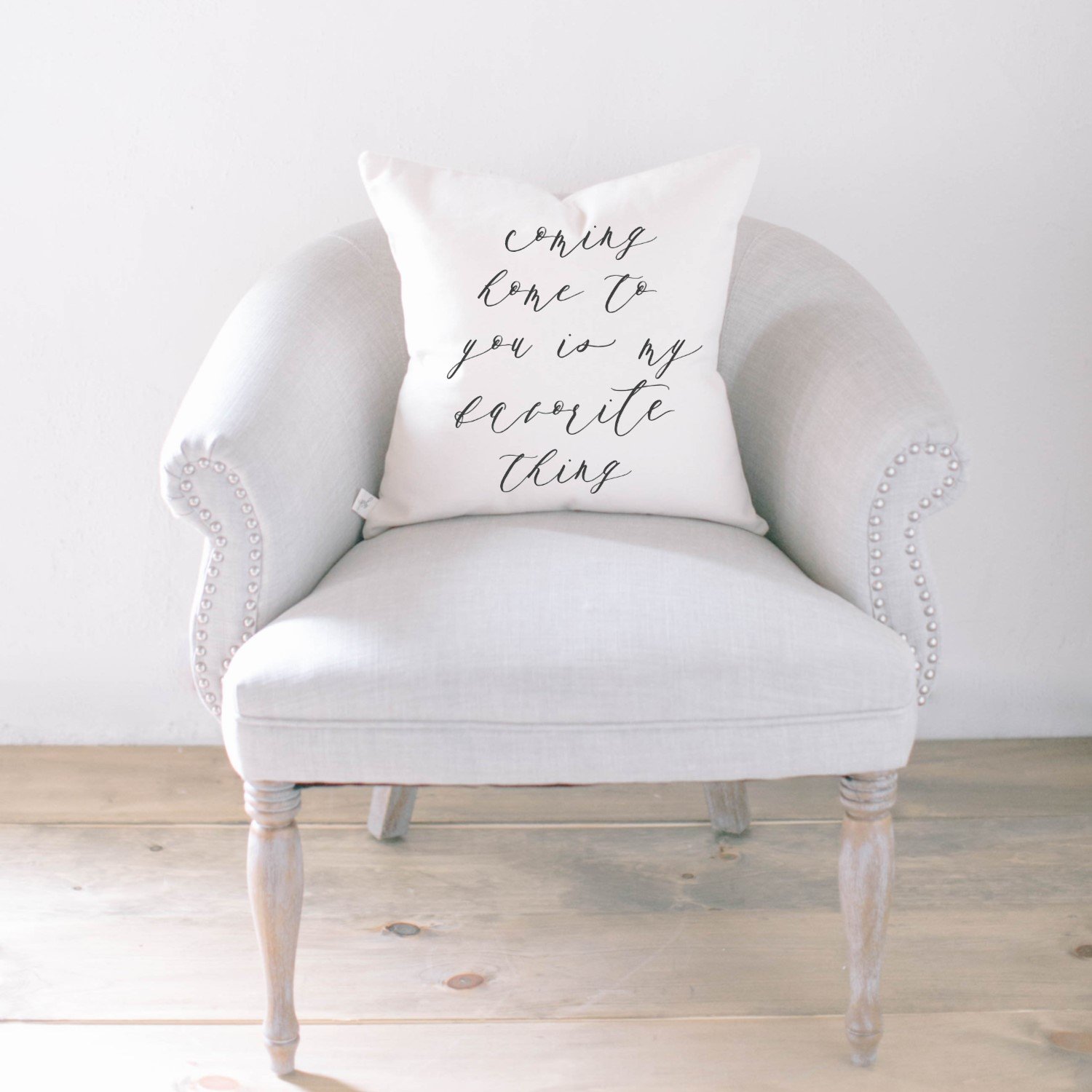 A cozy pillow with the quote 'Coming Home To You Is My Favorite Thing' in elegant calligraphy, made from 100% natural cotton fabric.