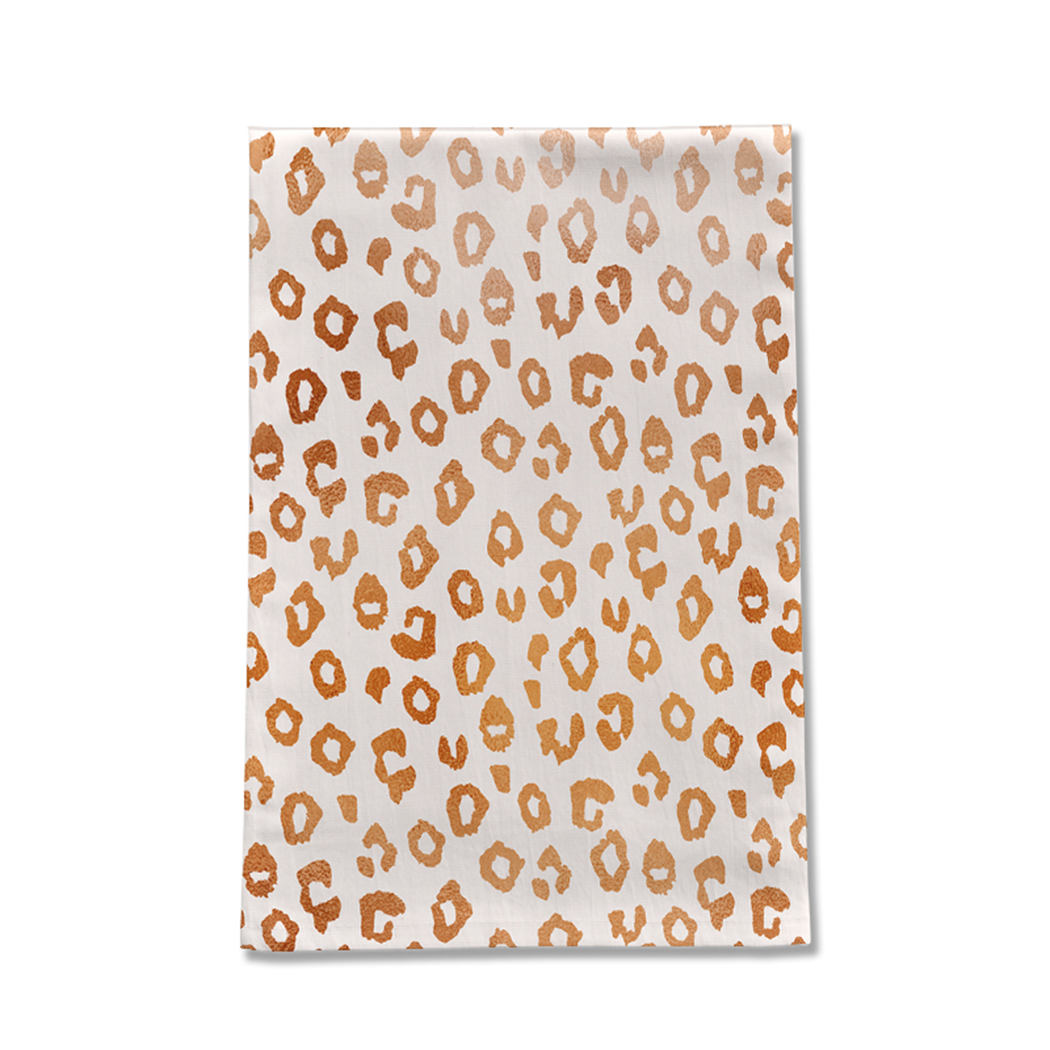 Copper leopard print tea towel made of cotton twill, featuring a stylish design and hemmed edges, perfect for kitchen use.