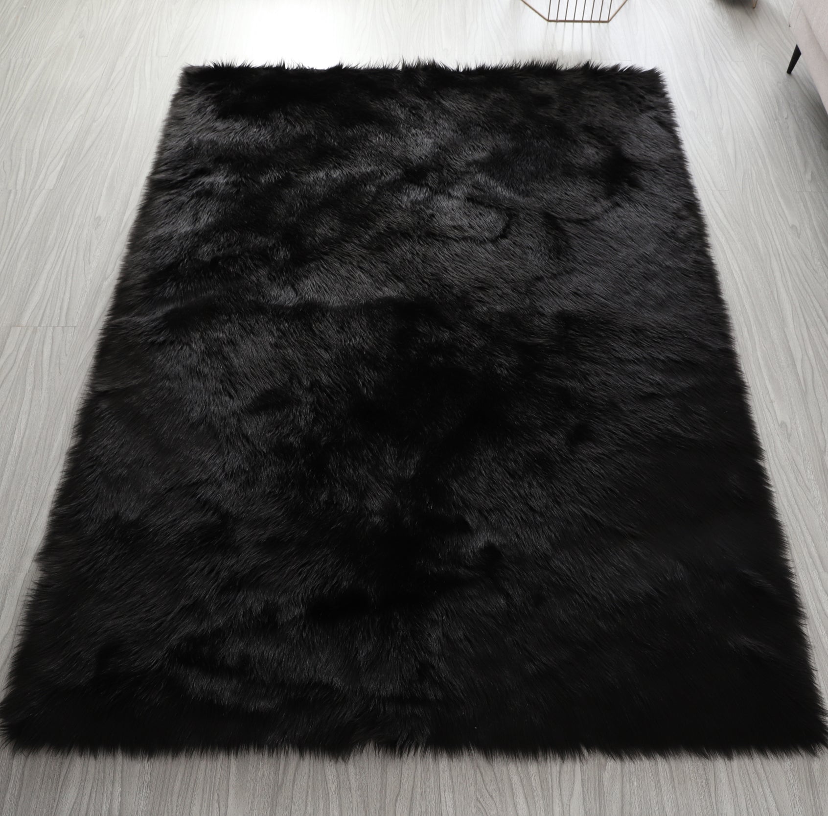 Cozy Ultra Soft Fluffy Faux Fur Black Area Rug showcasing its plush texture and elegant design, perfect for enhancing any living space.