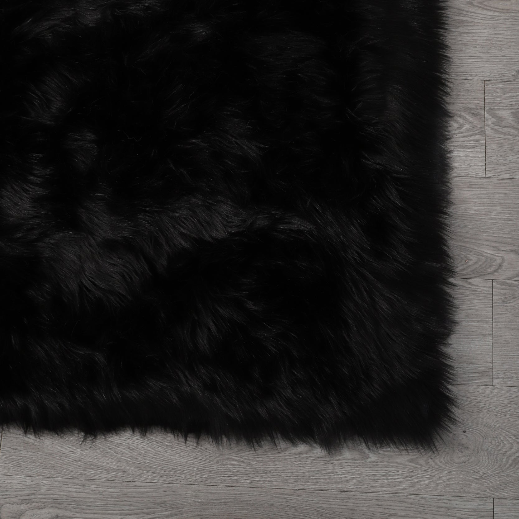 Cozy Ultra Soft Fluffy Faux Fur Black Area Rug showcasing its plush texture and elegant design, perfect for enhancing any living space.