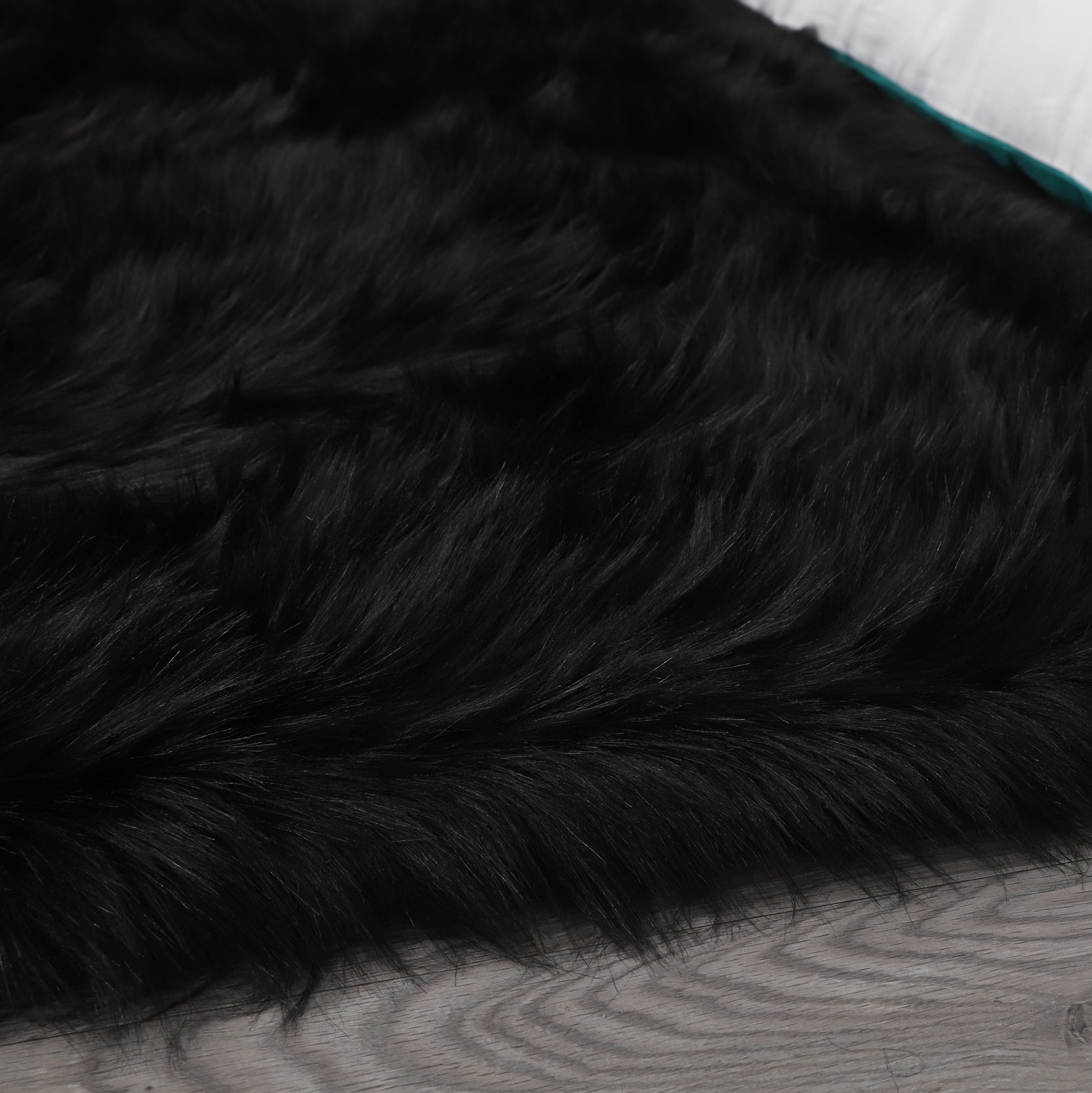 Cozy Ultra Soft Fluffy Faux Fur Black Area Rug showcasing its plush texture and elegant design, perfect for enhancing any living space.