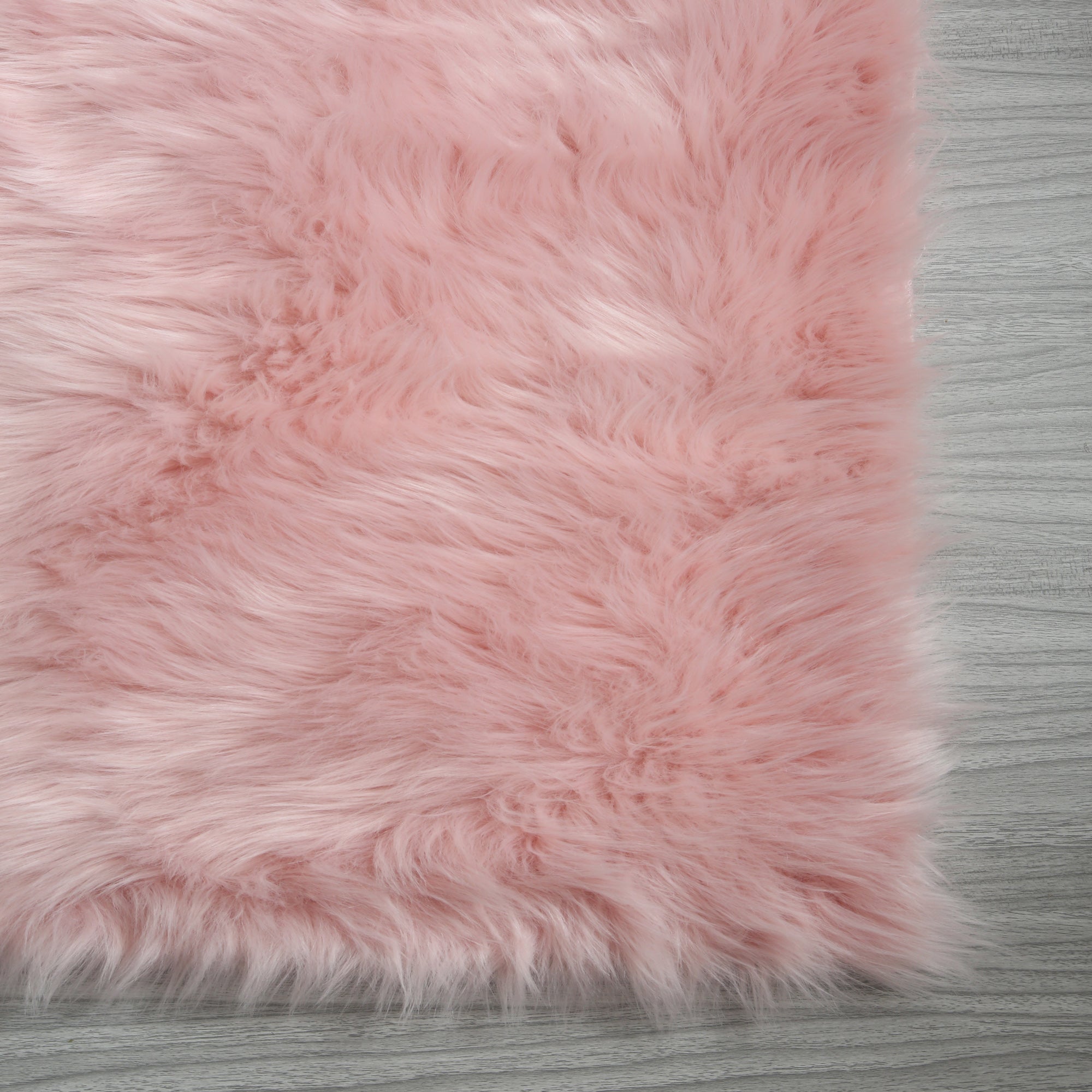 Cozy Ultra Soft Fluffy Faux Fur Pink Area Rug showcasing its plush texture and vibrant color, perfect for enhancing contemporary living spaces.