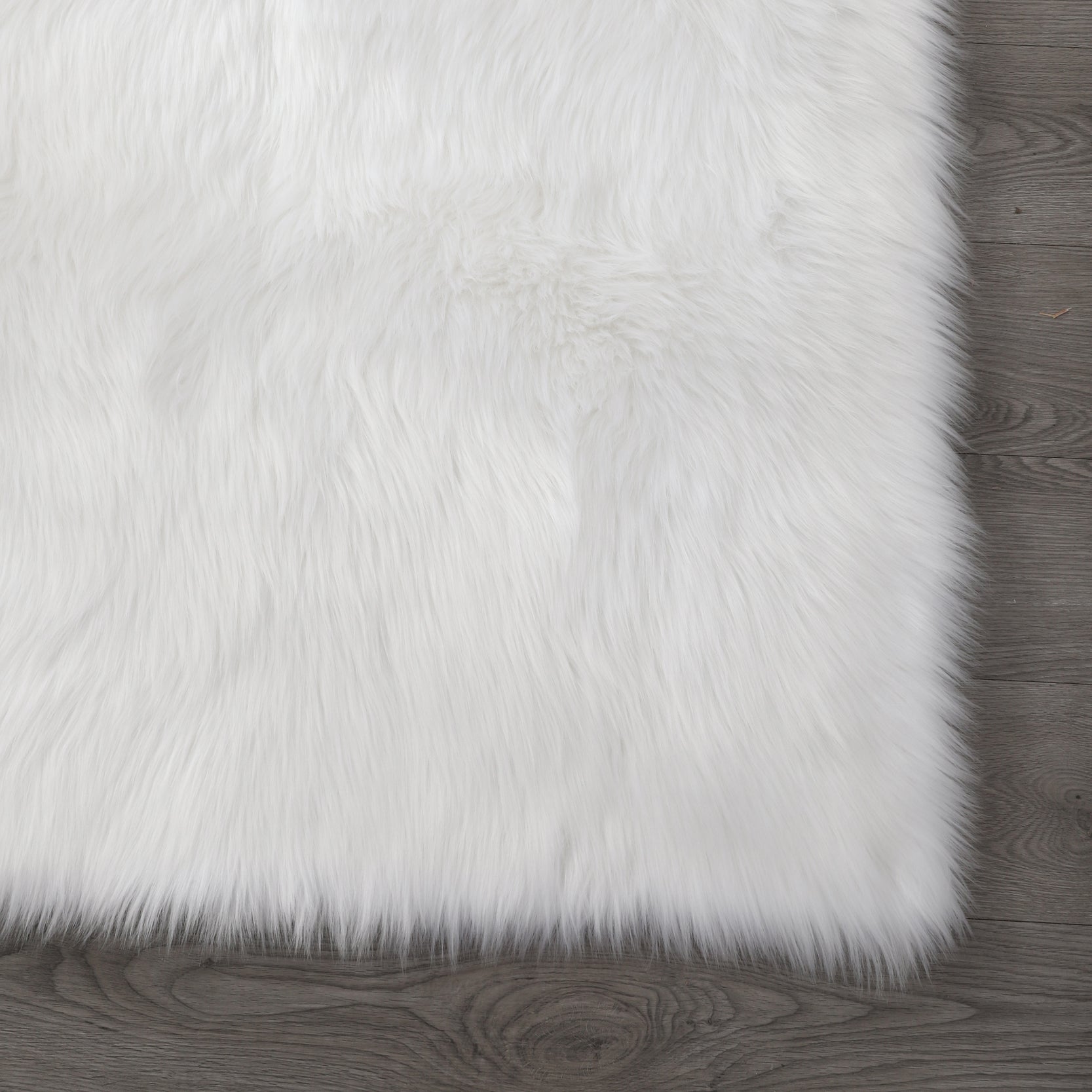 Cozy Ultra Soft Fluffy Faux Fur White Area Rug displayed in a modern living room setting, showcasing its plush texture and elegant design.