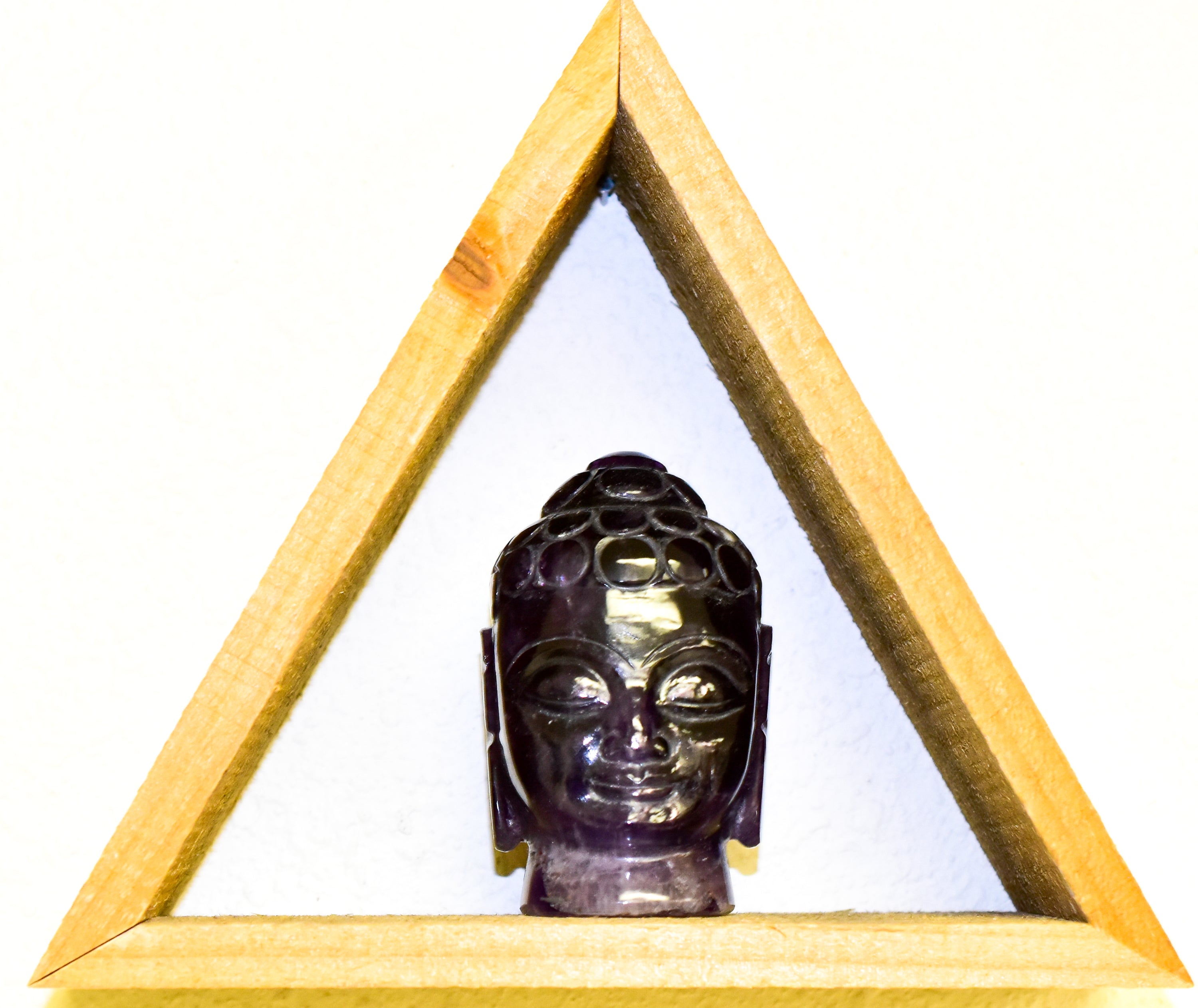 A stunning Crystal Buddha Head made from grade A Amethyst and Clear Quartz, showcasing deep purple and clear features, perfect for home decor.