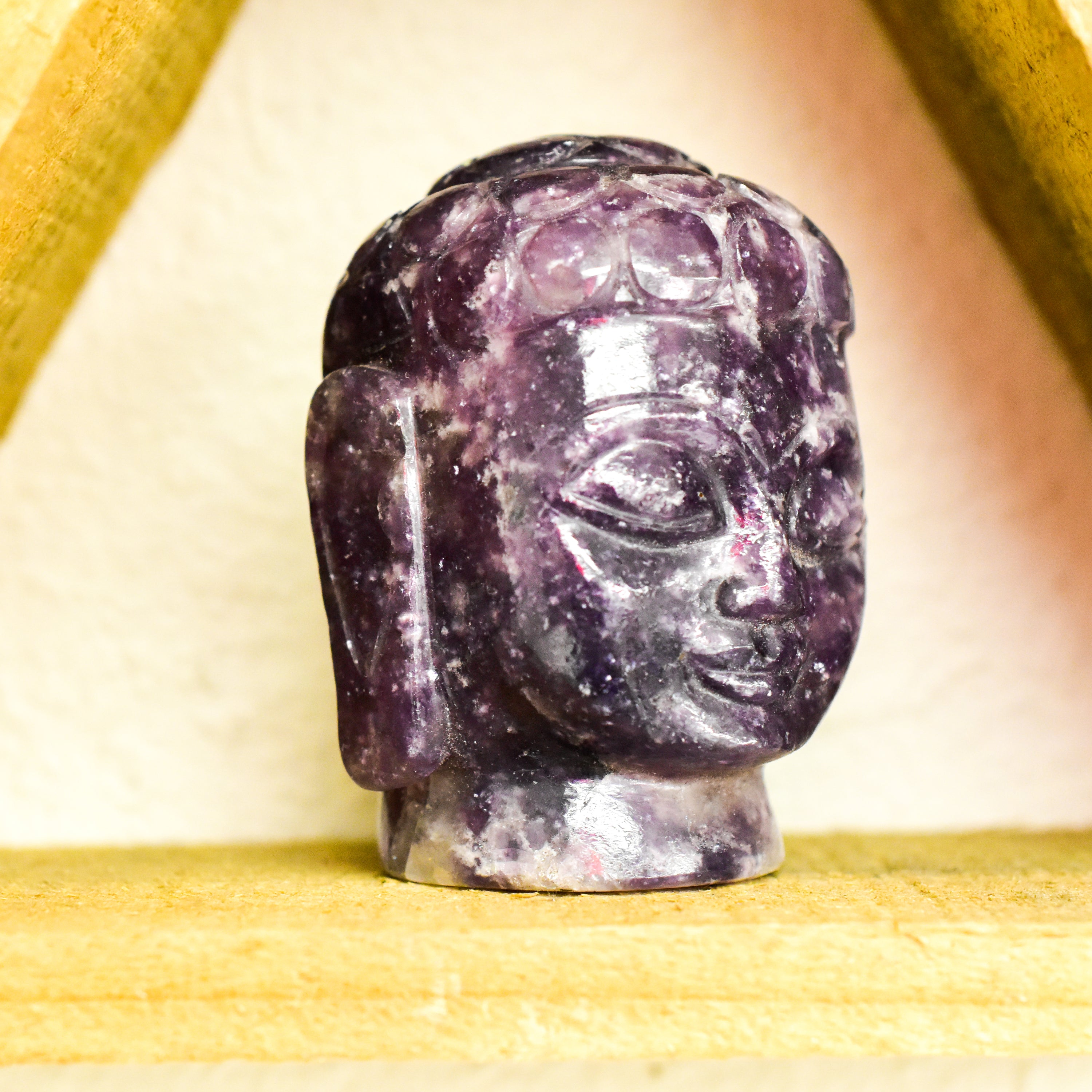 A stunning Crystal Buddha Head made from grade A Amethyst and Clear Quartz, showcasing deep purple and clear features, perfect for home decor.