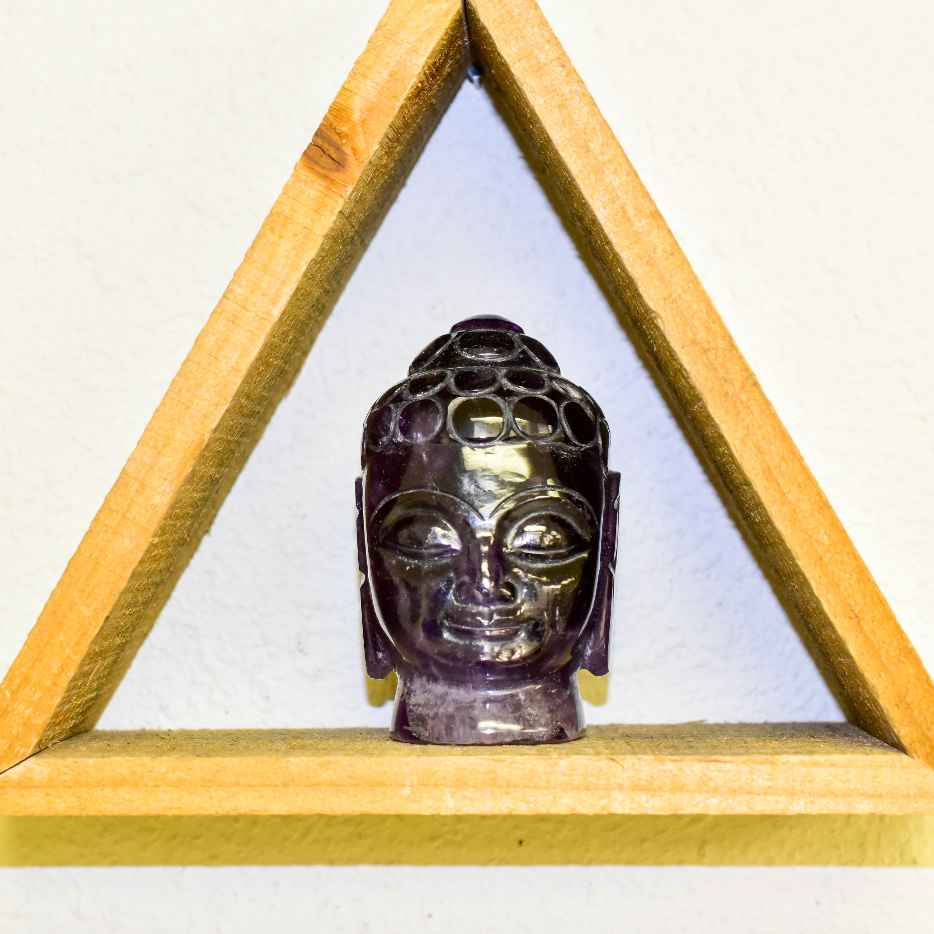 A stunning Crystal Buddha Head made from grade A Amethyst and Clear Quartz, showcasing deep purple and clear features, perfect for home decor.