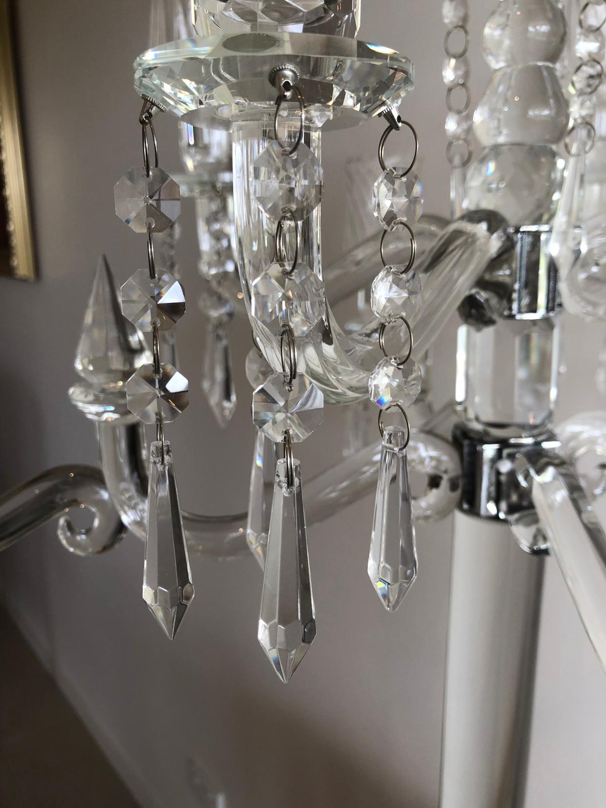 Elegant 9-head crystal candelabra standing 86cm tall, showcasing its intricate design and sparkling finish, perfect for weddings and events.