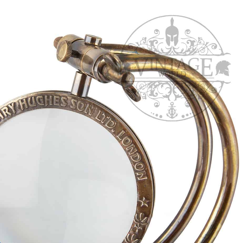 Curved Arm 100mm Desk Magnifying Glass with antique brass finish and wooden base, showcasing its elegant design.