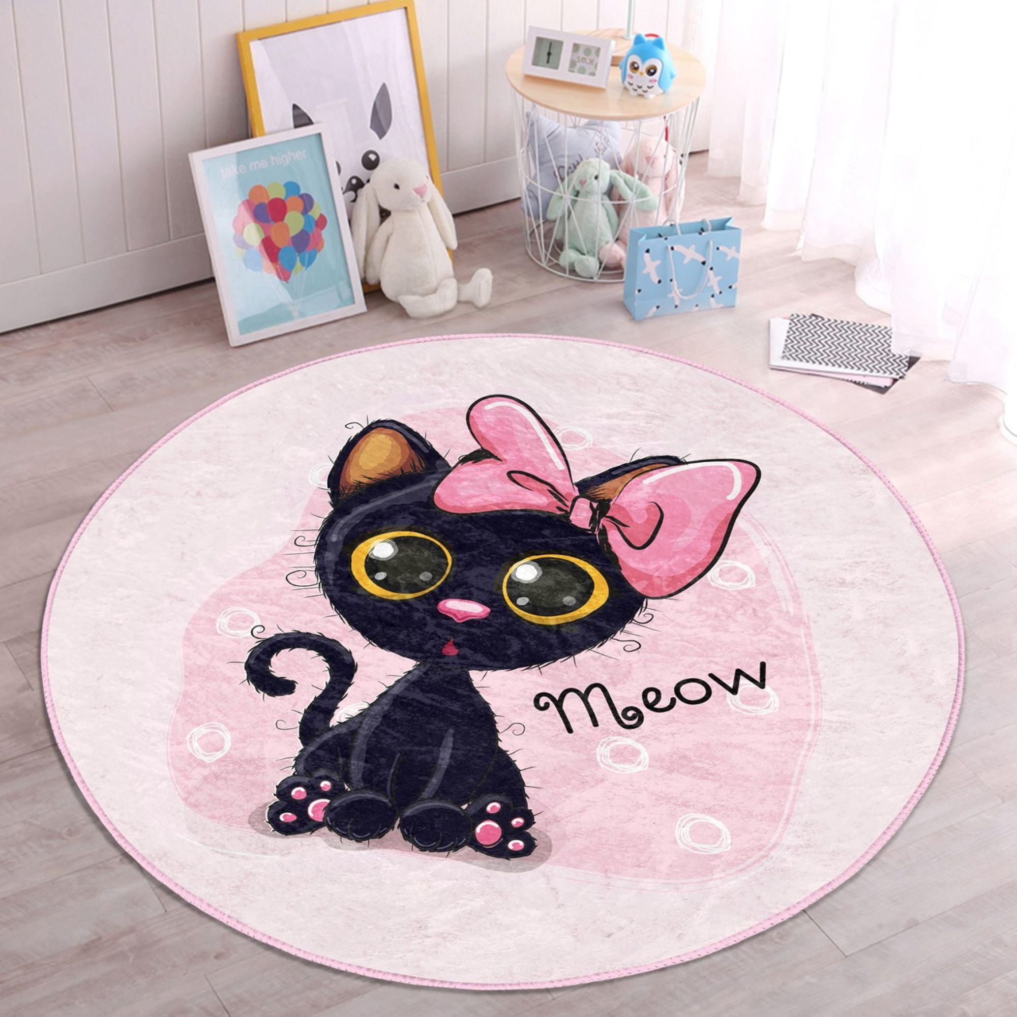 A soft, round rug featuring a cute pink kitty pattern, perfect for kids' rooms, showcasing vibrant colors and plush texture.