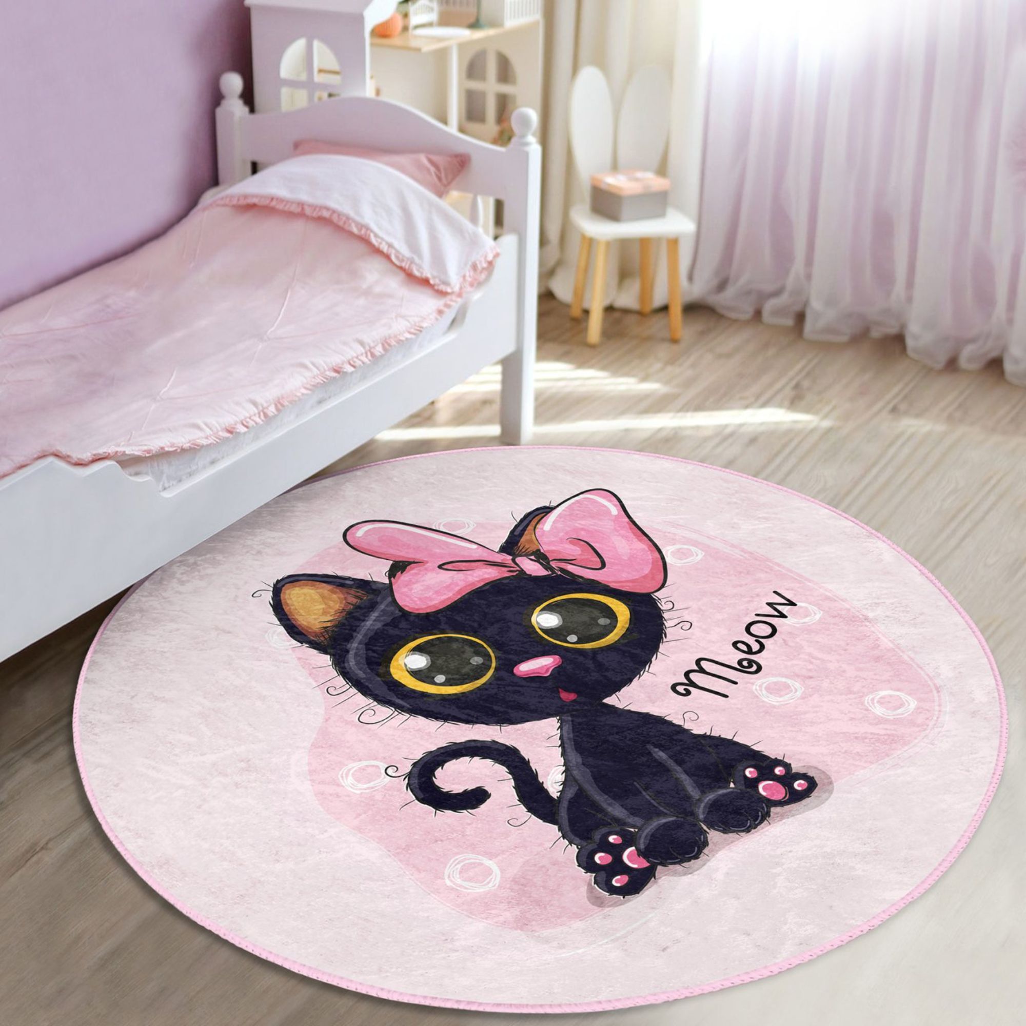 A soft, round rug featuring a cute pink kitty pattern, perfect for kids' rooms, showcasing vibrant colors and plush texture.