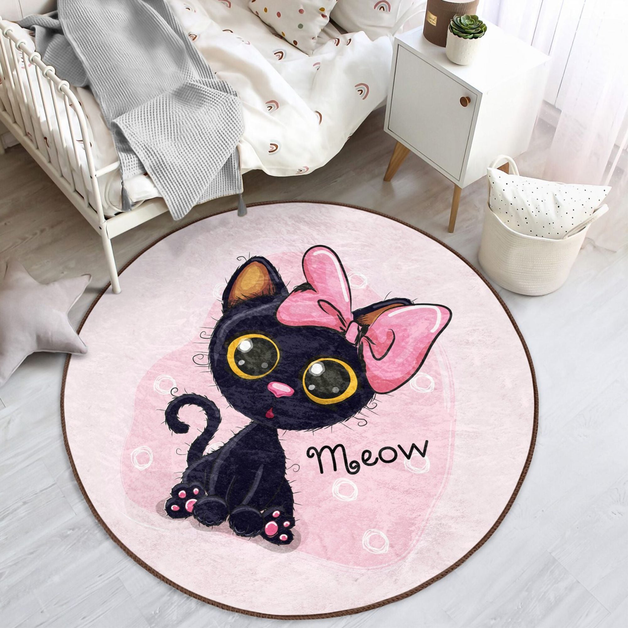 A soft, round rug featuring a cute pink kitty pattern, perfect for kids' rooms, showcasing vibrant colors and plush texture.