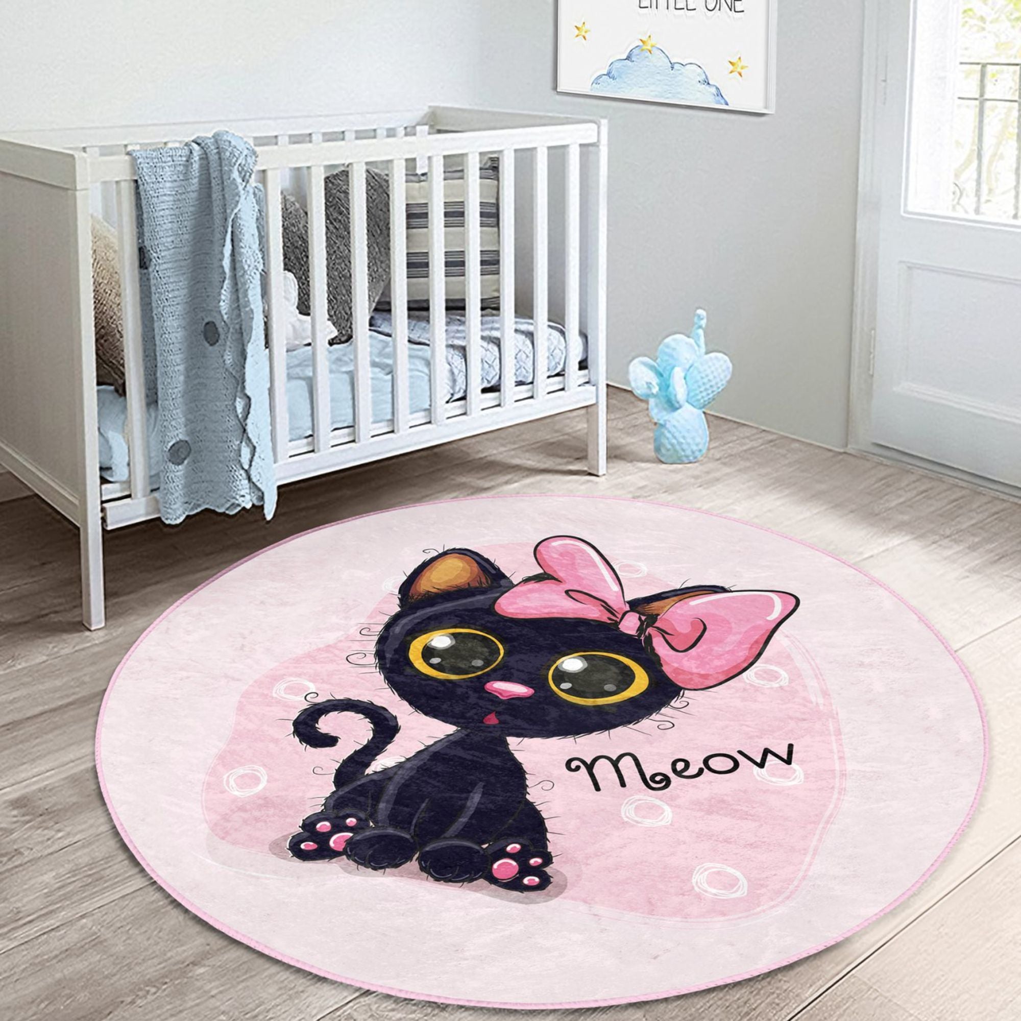 A soft, round rug featuring a cute pink kitty pattern, perfect for kids' rooms, showcasing vibrant colors and plush texture.