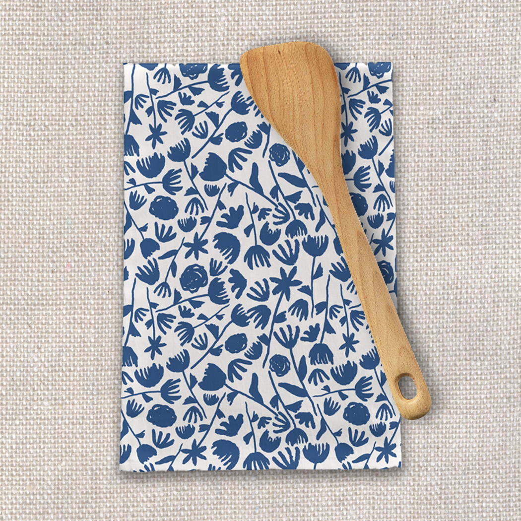 Dark blue floral tea towel made of cotton twill, featuring a charming floral design and hemmed edges, perfect for kitchen use.