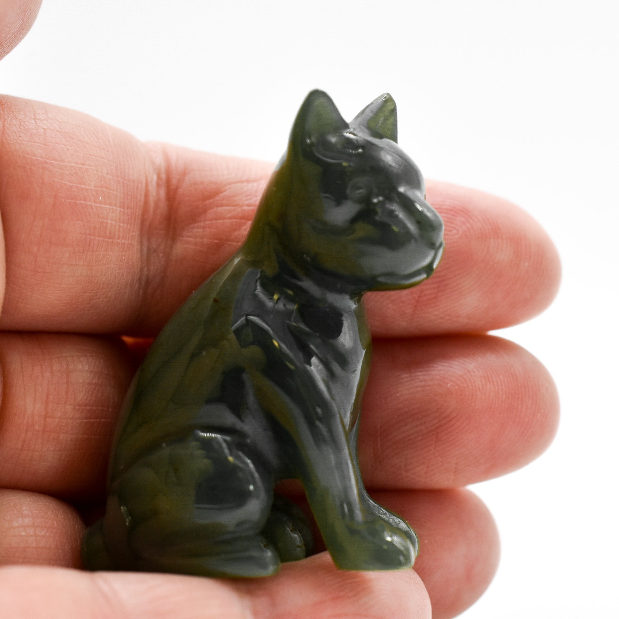 Handcrafted dark green jade dog figurines, showcasing intricate details and rich color, symbolizing luck and protection.