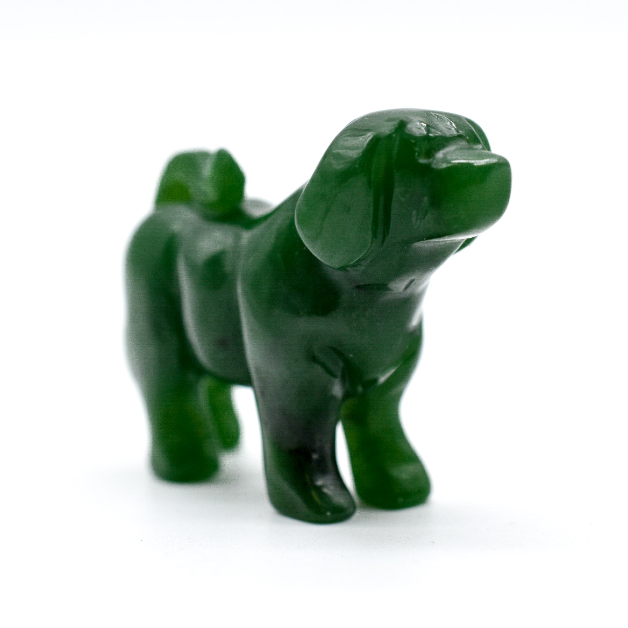 Handcrafted dark green jade dog figurines, showcasing intricate details and rich color, symbolizing luck and protection.