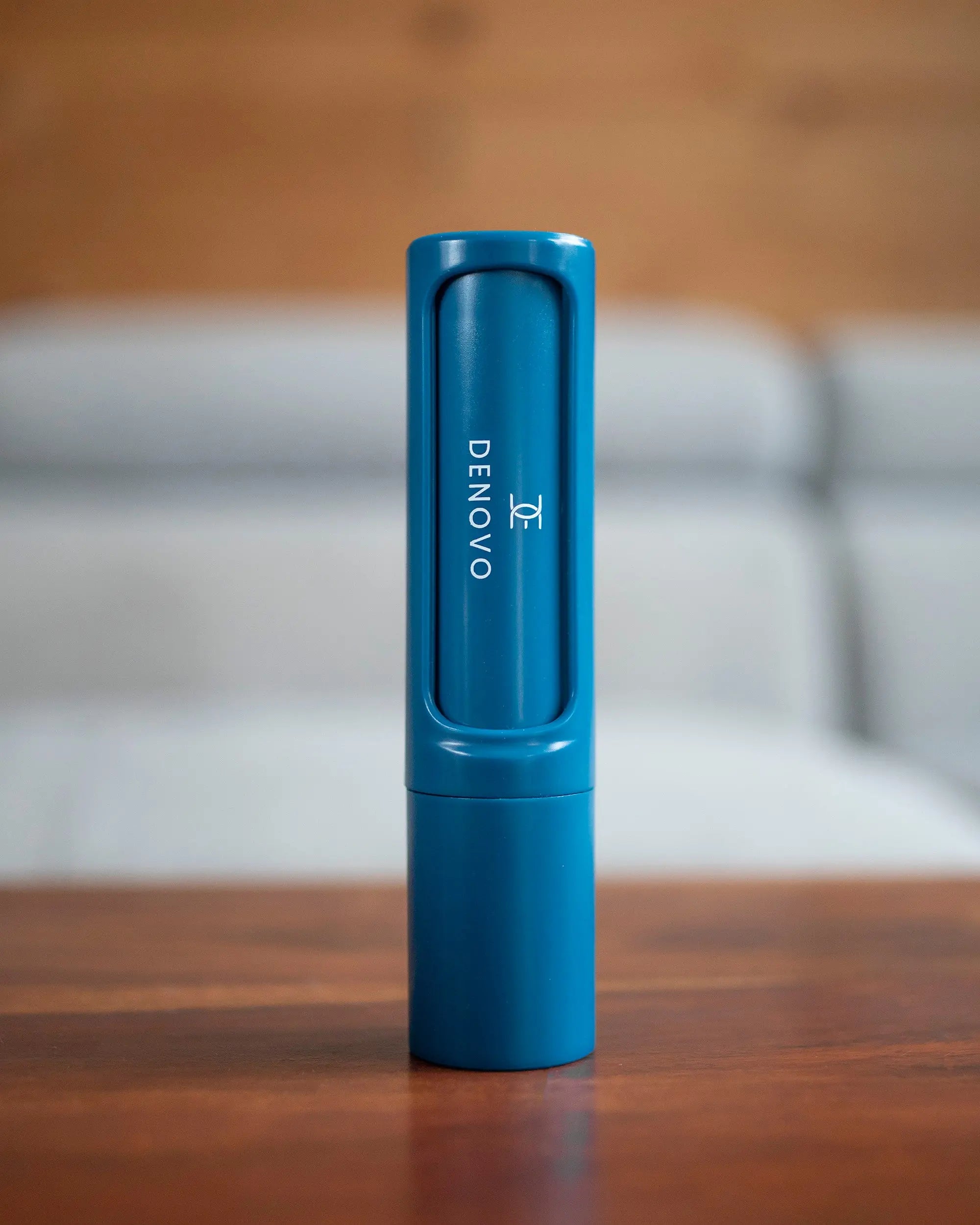 De Novo™ On-The-Go Lint Roller in a compact design, showcasing its self-cleaning feature and travel-friendly size.