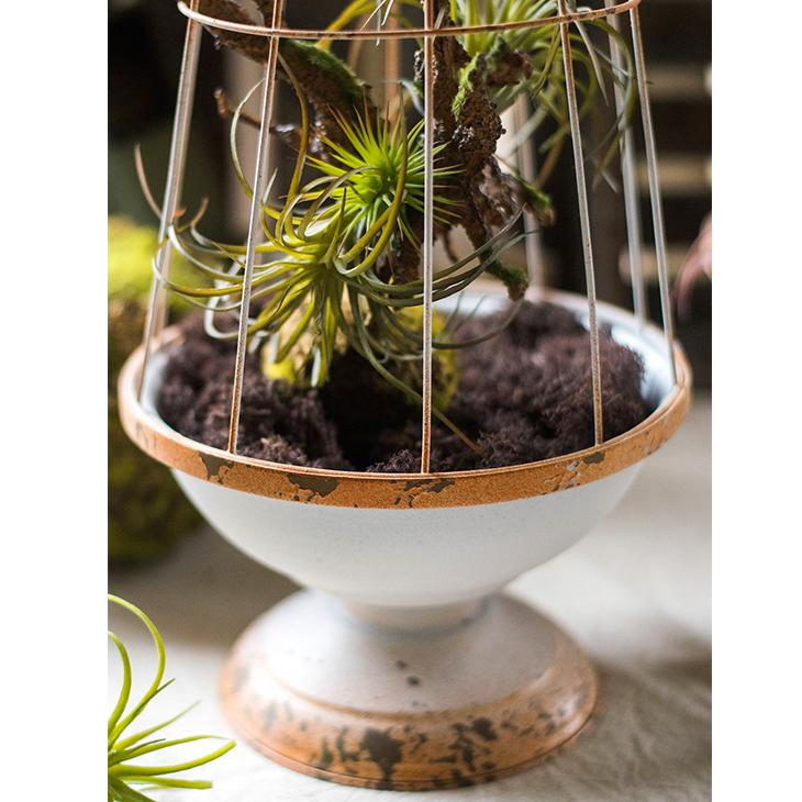 A decorative iron bird cage in white and rust colors, showcasing intricate designs and available in two sizes.