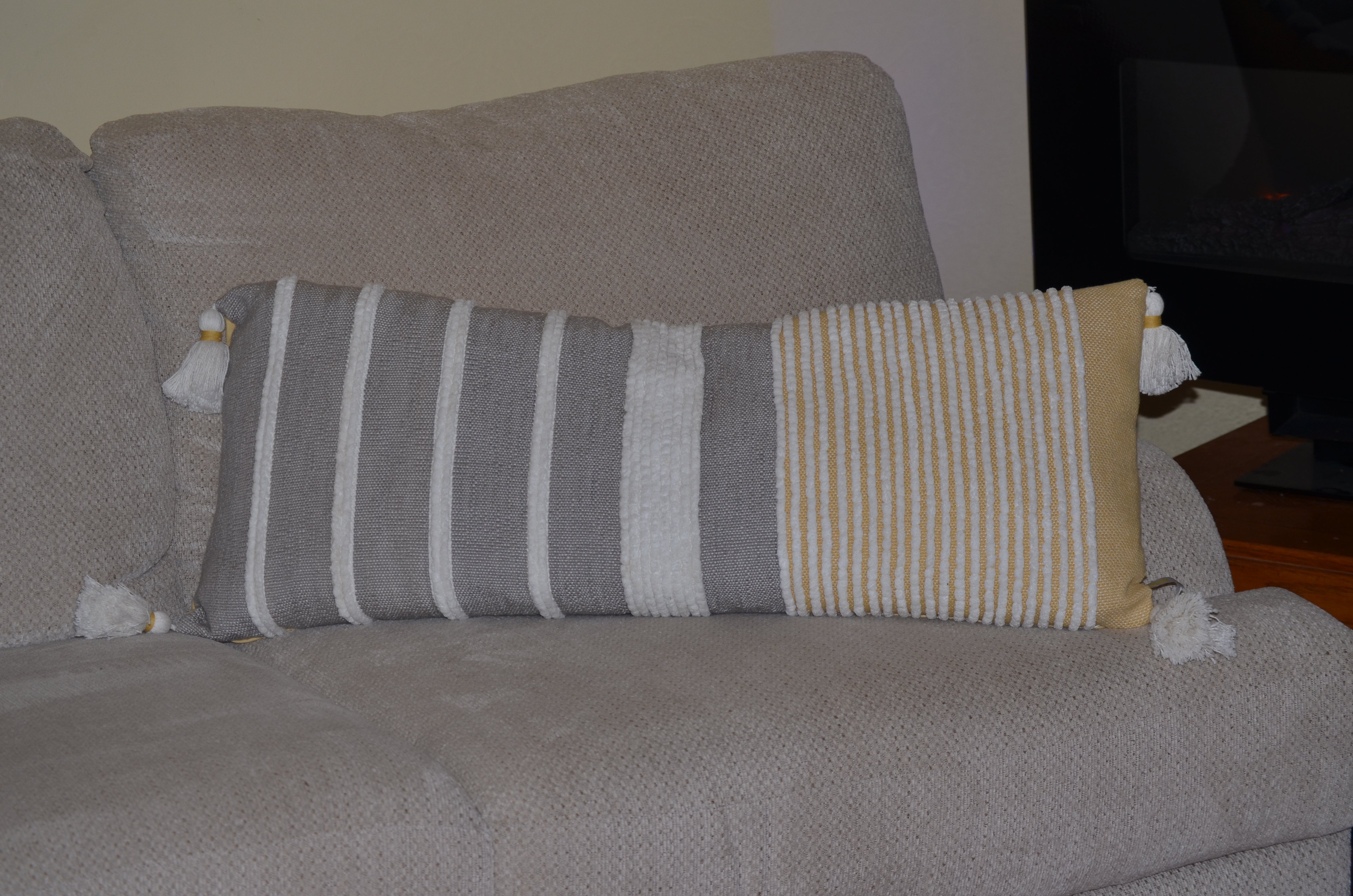 Decorative long grey stripes throw pillow measuring 14x36 inches, featuring a handloom woven textured design in grey, white, and ocher colors.