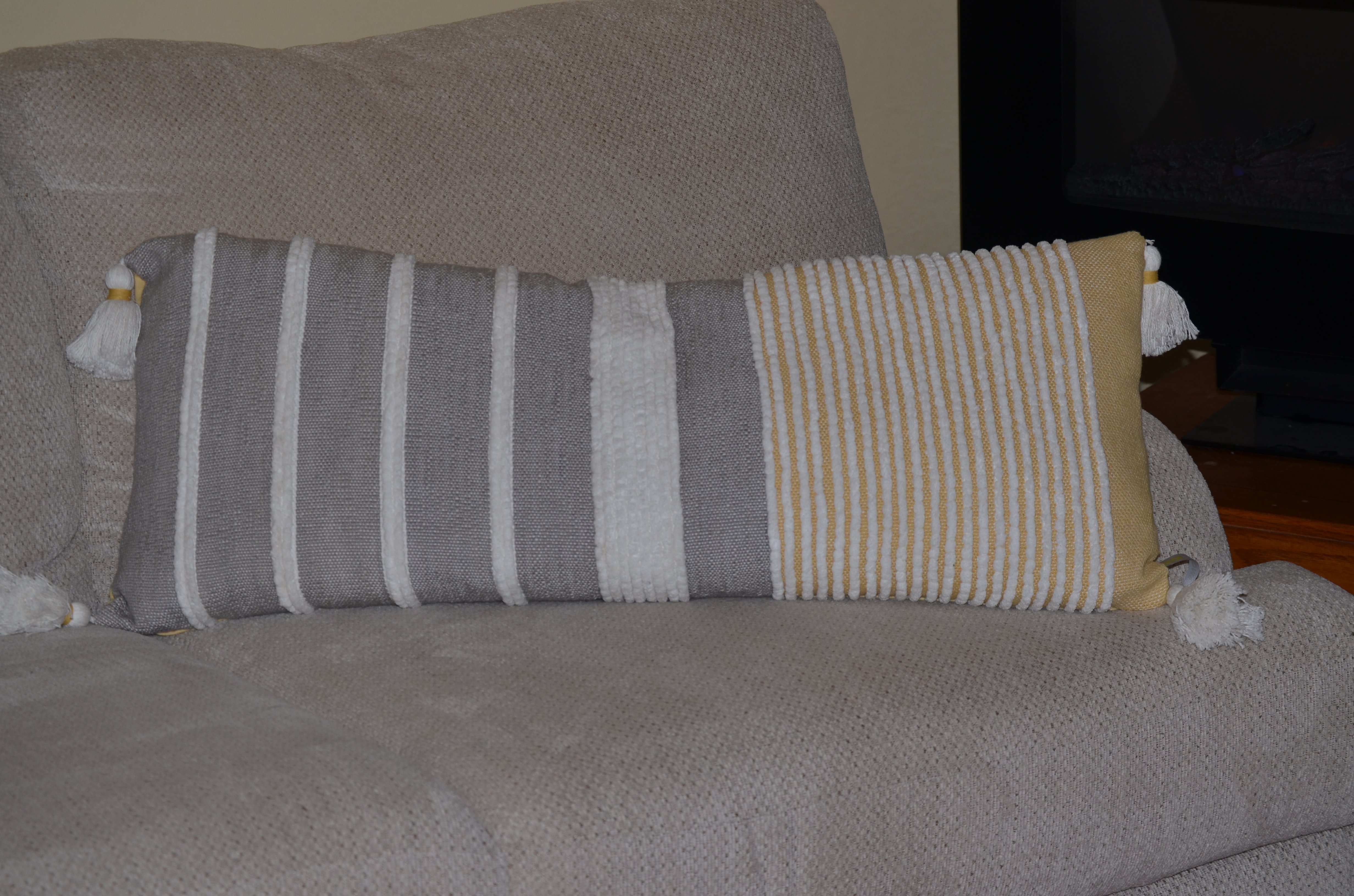 Decorative long grey stripes throw pillow measuring 14x36 inches, featuring a handloom woven textured design in grey, white, and ocher colors.