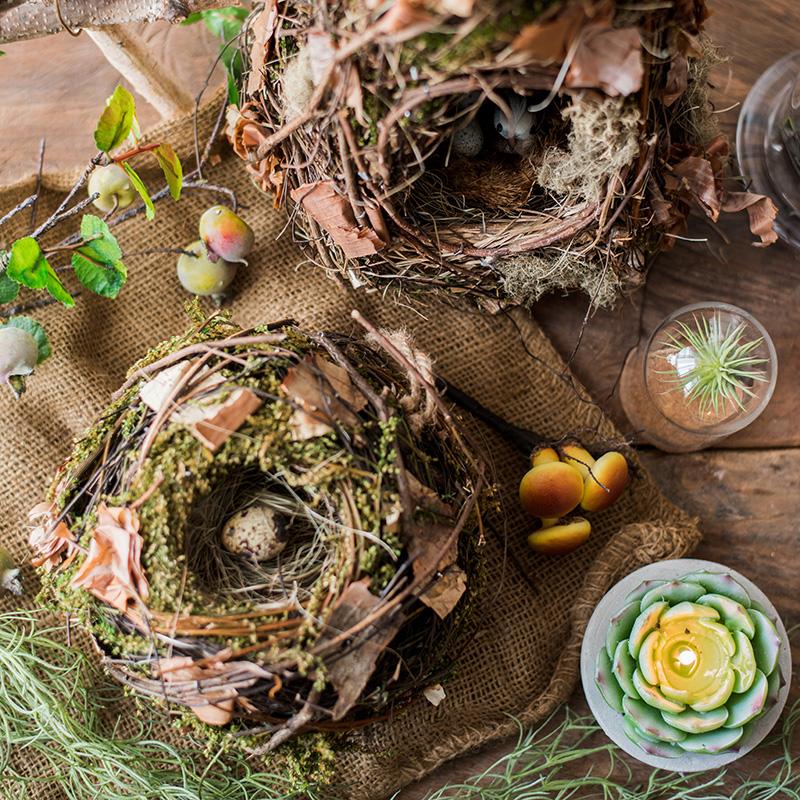 A beautifully crafted Decorative Natural Bird's Nest made from grass and willow, showcasing earthy tones of brown and green.