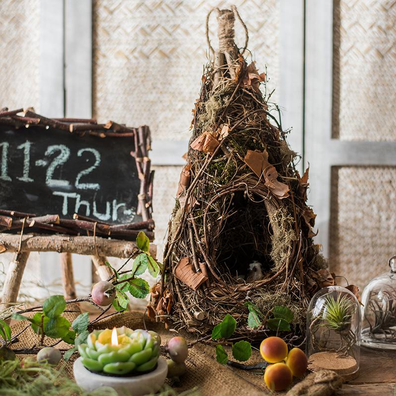 A beautifully crafted Decorative Natural Bird's Nest made from grass and willow, showcasing earthy tones of brown and green.