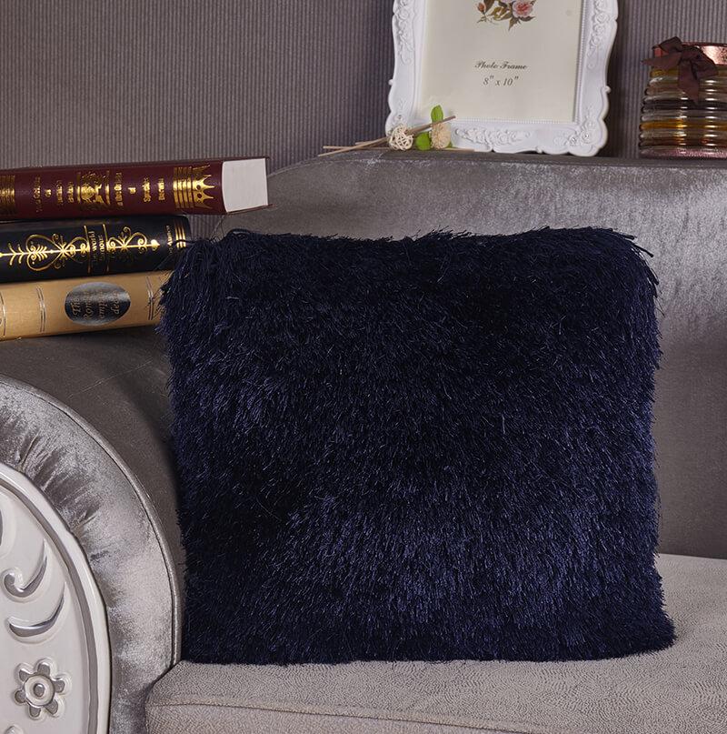 A cozy blue decorative shaggy pillow, hand-tufted, square shape, measuring 18 inches by 18 inches, perfect for home decor.