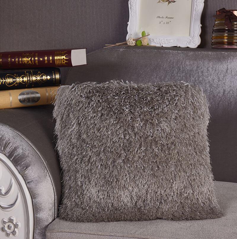 A cozy grey decorative shaggy pillow, hand-tufted, square shape, measuring 18 inches by 18 inches, perfect for home decor.