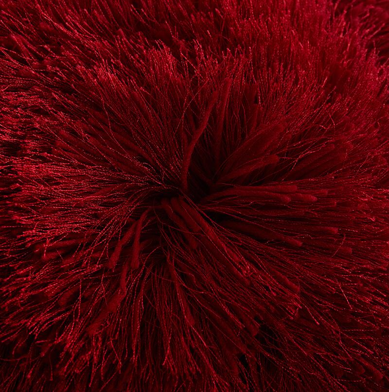 A cozy red decorative shaggy pillow, hand tufted, square shape, measuring 18 inches by 18 inches, perfect for home decor.