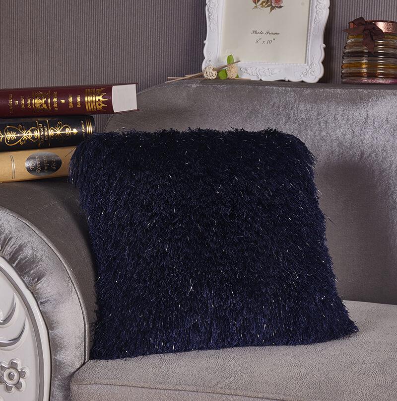 A cozy blue decorative shaggy pillow with Lurex accents, hand tufted and square-shaped, measuring 18 inches by 18 inches.