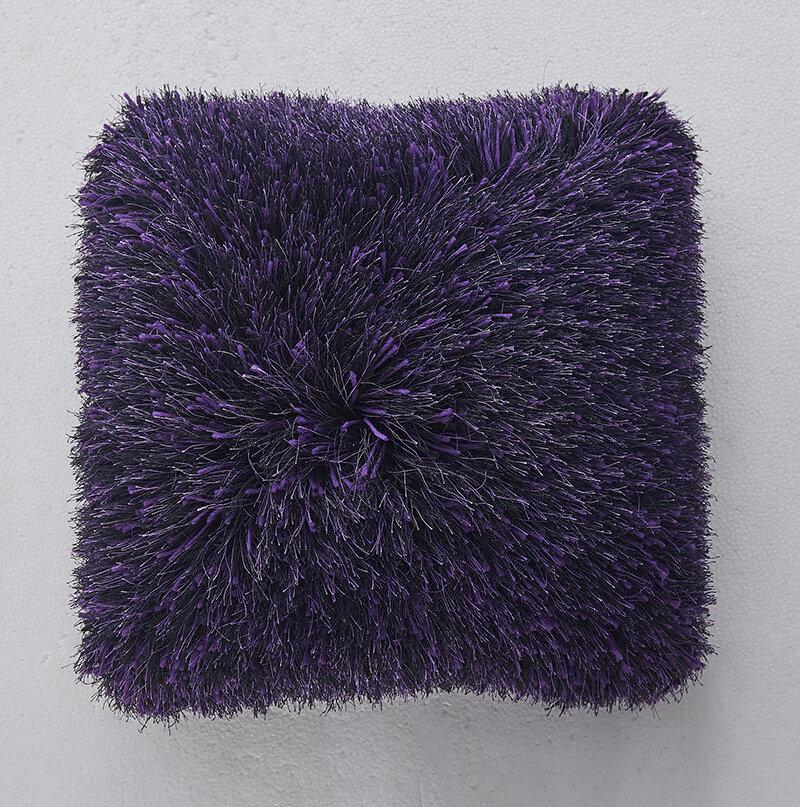 Decorative shaggy pillow in purple with lurex accents, featuring a plush texture and stylish design, perfect for home decor.