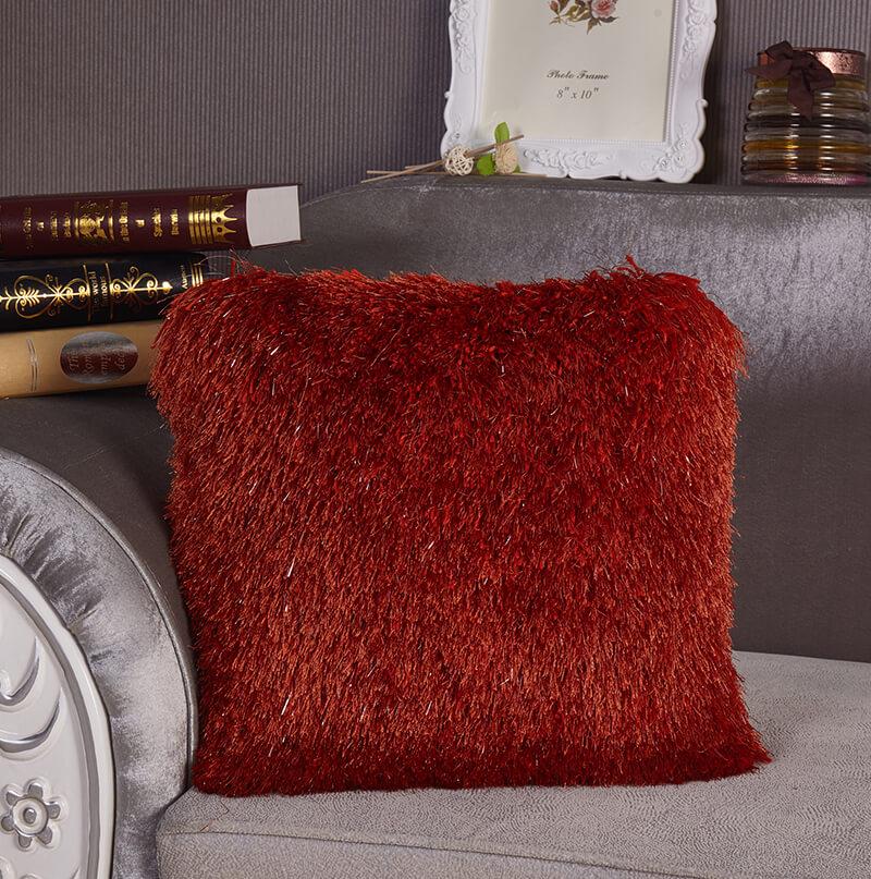 Decorative shaggy pillow in rust color with Lurex accents, hand tufted and soft, measuring 18x18 inches.