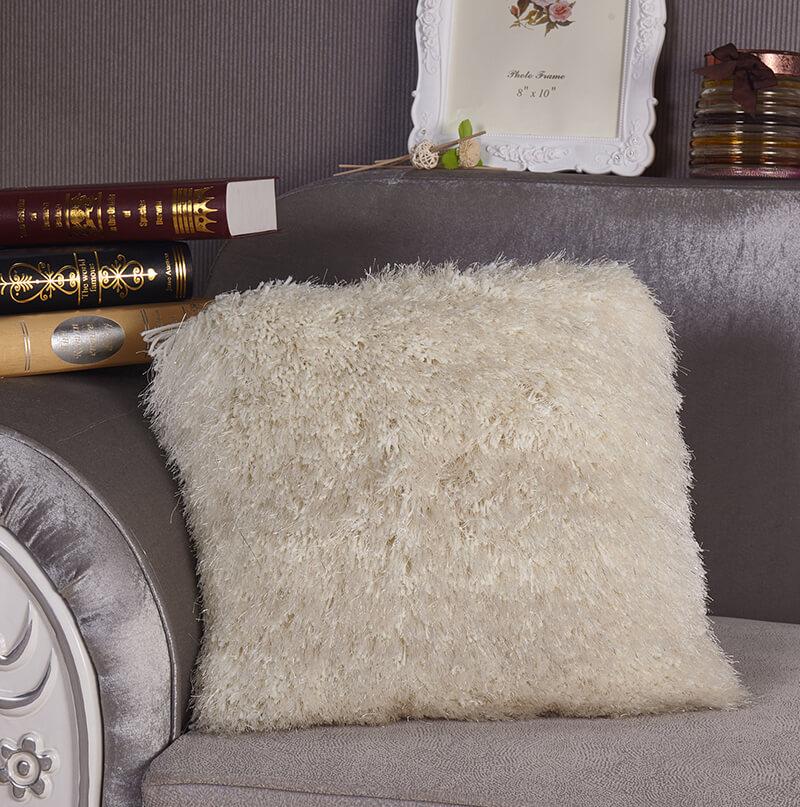 A cozy white decorative shaggy pillow with Lurex threads, hand tufted and square-shaped, measuring 18x18 inches.