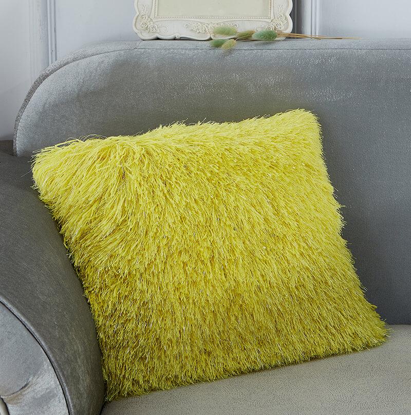 Decorative shaggy pillow in vibrant yellow with lurex threads, showcasing a retro modern design, perfect for adding glamour to any room.