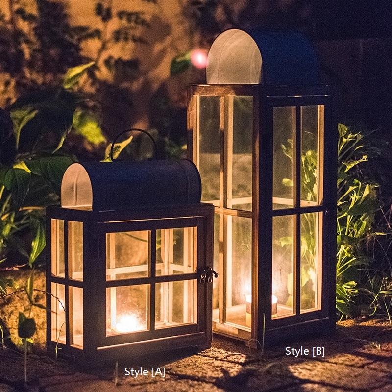 A beautifully crafted decorative table lantern made of wood and glass, featuring a rustic design with a candle inside, perfect for home decor.