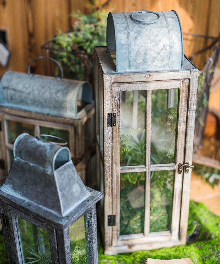 A beautifully crafted decorative table lantern made of wood and glass, featuring a rustic design with a candle inside, perfect for home decor.