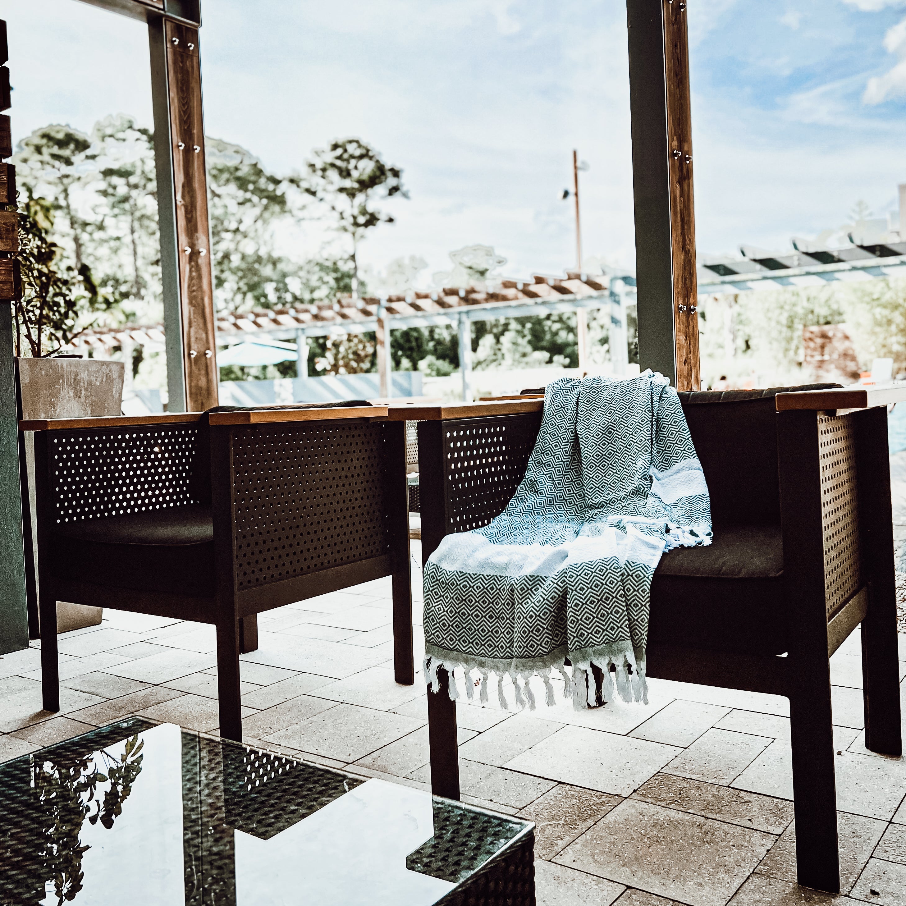 A luxurious Diamond Towel 200GSM in blue with decorative tassels, showcasing its oversized design and unique diamond pattern.